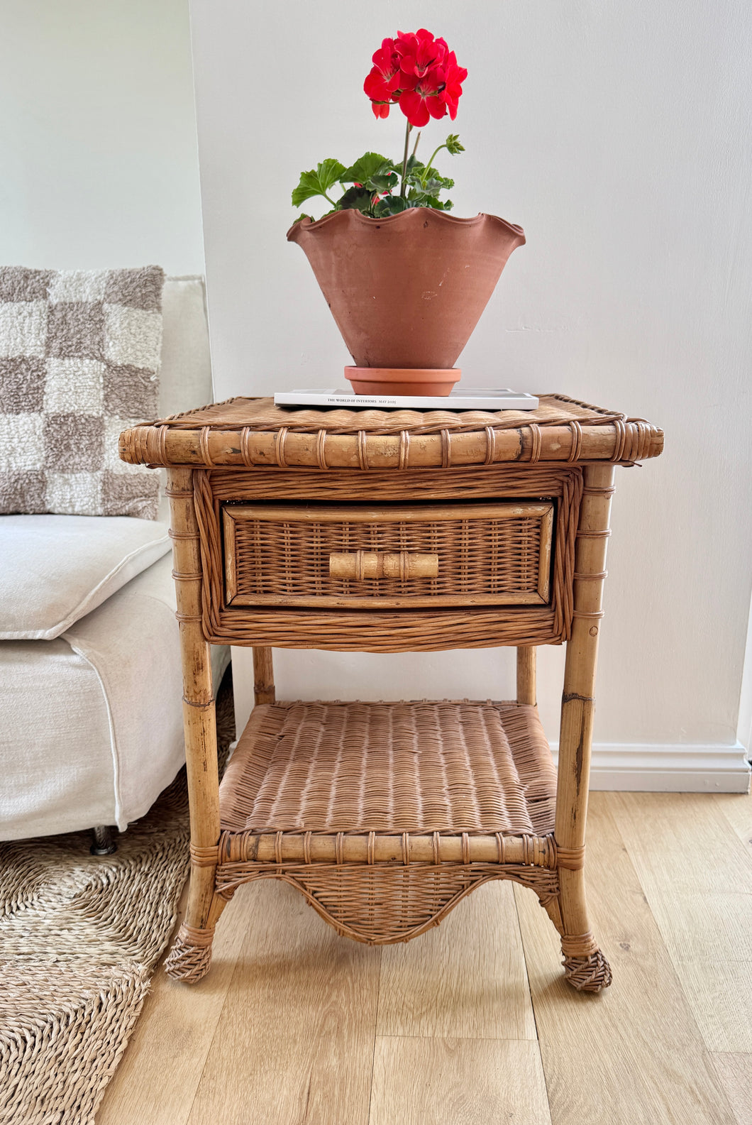 A vintage wicker scalloped bedside