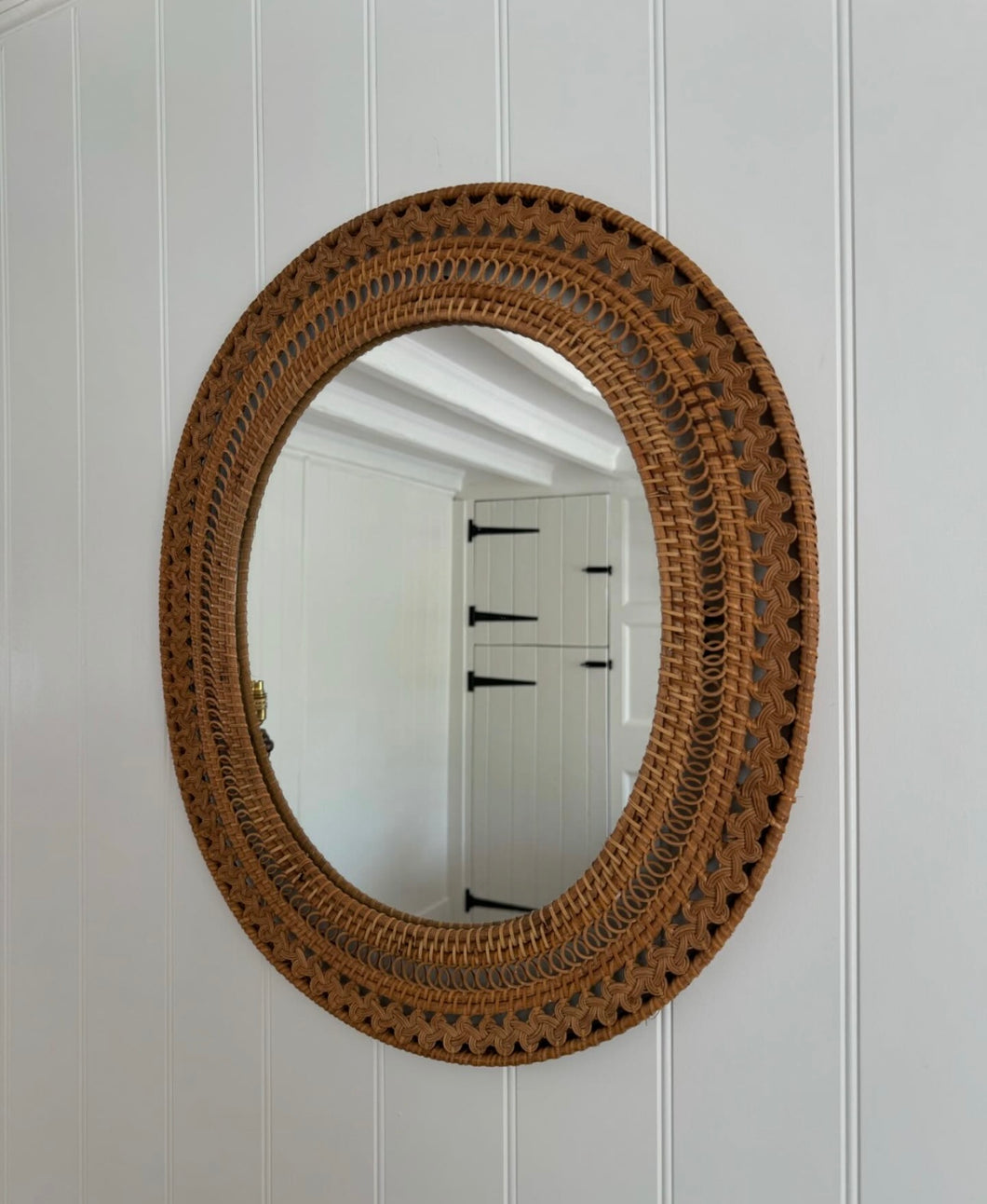 Vintage plaited rattan wall mirror.